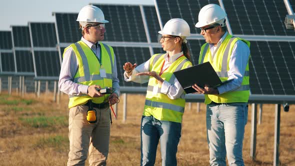 Technicians Are Discussing Inspection of Solar Batteries alt