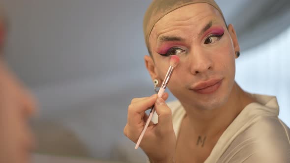 Closeup Reflection in Mirror of Confident Transgender Caucasian Young Woman in Wig Cap Applying alt