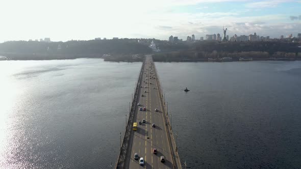 Urban Traffic on a Patona Bridge Over a River