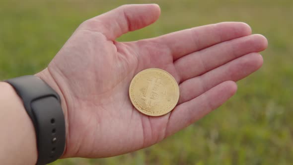 Gold Coin Bitcoin in the Palm of a Businessman a Symbol of Cryptocurrency