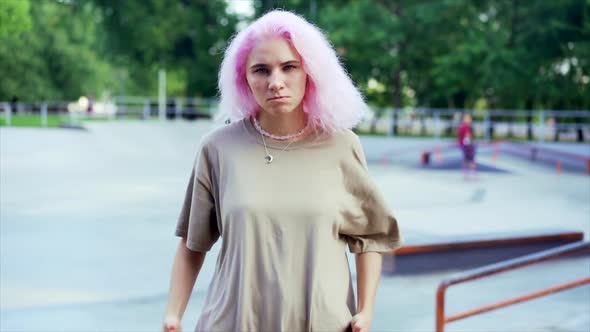 Young Dancing Teenager Girl Enjoying Funky Hip-hop Moves. Modern Woman with Pink Dyed Hair alt