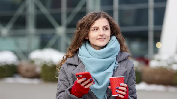 Portrait of Happy Beautiful Curly Woman With Coffee Cup Takeaway Use Mobile Phone Texting Messages
