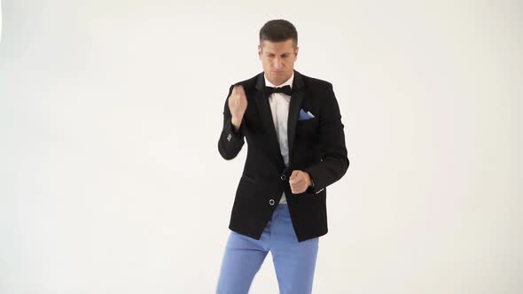 сharismatic showman is mimicing and playing the drums in the similitude of a drummer at concert alt