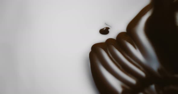 Closeup Macro Shot Hot Melted Liquid Chocolate or Brown Caramel Sauce Flows alt