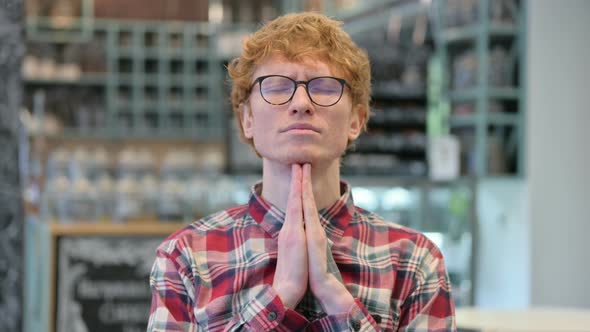 Hopeful Young Redhead Man Praying alt