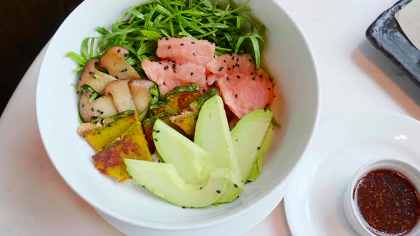Salmon Poke Bowl with Avocado Zucchini Top View alt