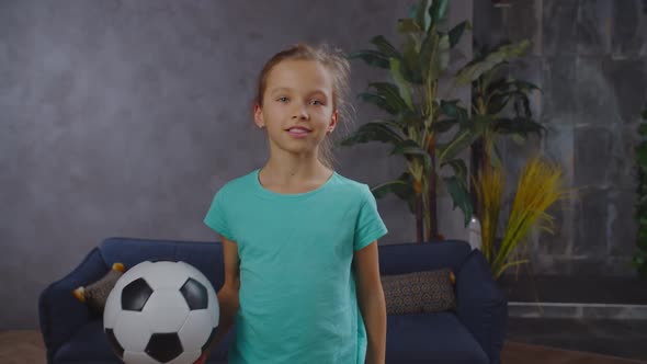 Lovely Little Girl Posing with Soccer Ball Indoor, Stock Footage | VideoHive 