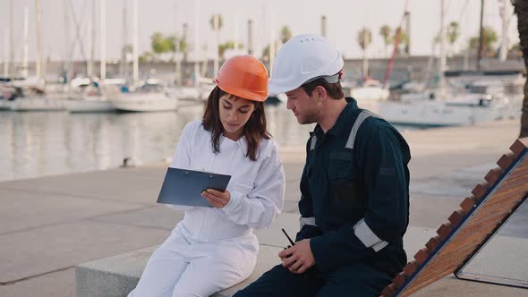 Female Surveyor Inspecting Boat of Seaman in Marina alt