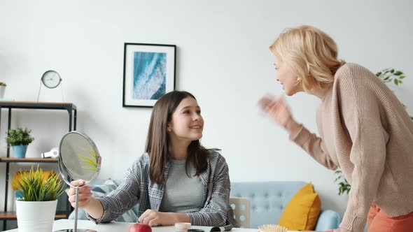 Loving Mother Helping Teenage Daughter with Makeup Applying Cosmetics Enjoying Leisure Time at Home alt