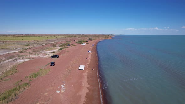 A Beach with Blue Water Color and Sandy Waves alt