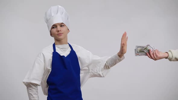 Little Chef Taking Bribe Cash Hiding Money in Pocket Standing at White Background alt