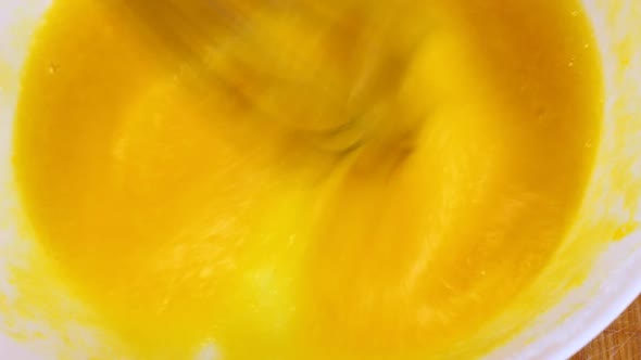 Woman Beat Broken Eggs with a Metal Whisk in a White Deep Dish Large Stick alt