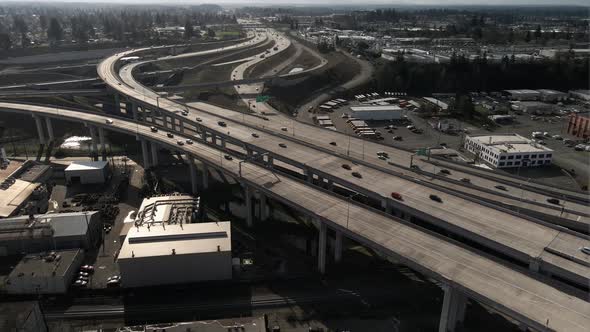 Commuter traffic meanders through the Nalley Valley viaduct, Tacoma WA, aerial descend alt