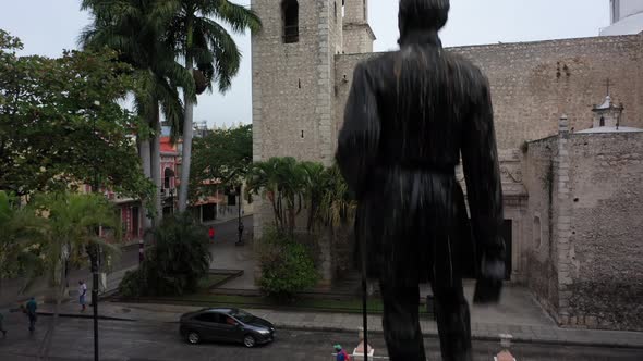 Aerial camera rising from behind a statue in Hidalgo Park continuing above the Rectory Jesus (third alt