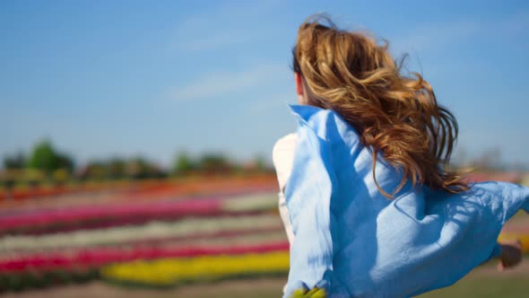 Back View of Happy Girl with Long Beautiful Hair Running in Slow Motion Outdoor alt