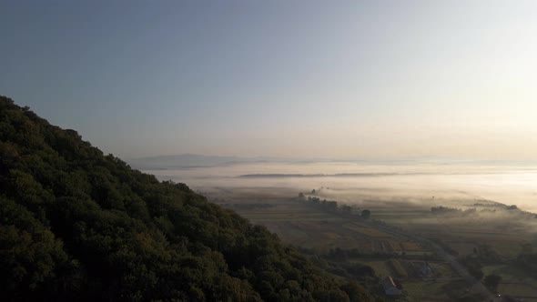 Mist covering vast beautiful landscape in Ukrainian flatlands. Aerial. alt