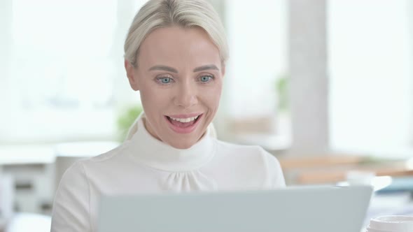Portrait of Young Businesswoman Celebrating Success on Laptop alt
