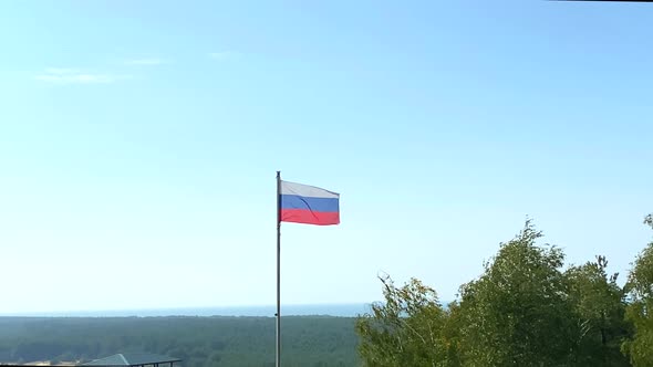 National Flag of Russia Waving Down in the Wind Against Blue Sky with Clouds