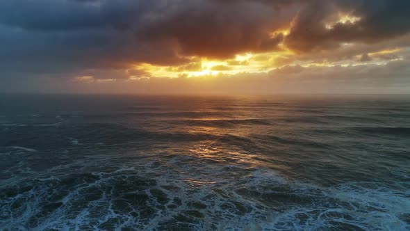 Aerial View on Big Waves and Dramatic Sunset Sky alt