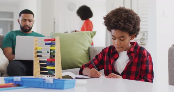 Boy doing homework at home alt
