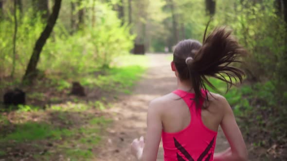 Active Woman Running in Spring Sunny Forest