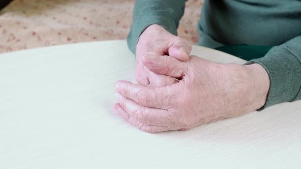 Closeup of the Wrinkled Old Tired Hands of an Elderly Man
