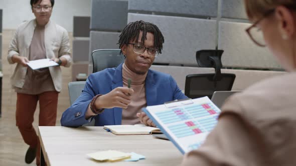 Multiethnic Businesspeople Working with Documents alt