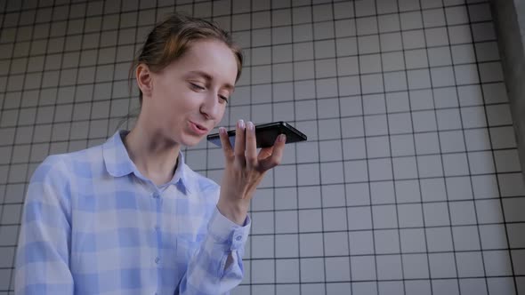 Online Technology: Woman Holding Smartphone and Using Voice Recognition Function
