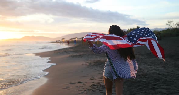 Happy Woman Running on Beach While Celebrateing Independence Day and Enjoying Freedom in USA alt
