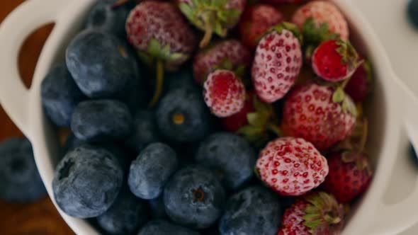 Zoom in to White Ceramic Bowl with Fresh Blueberries and Strawberries Berries alt