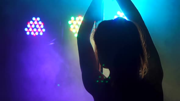 Young Woman's Silhouette Dancing on Pole in Smoke alt