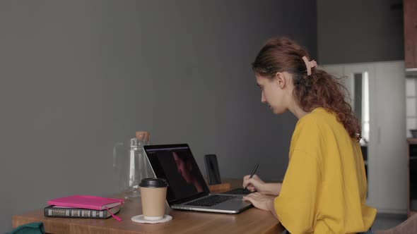 Woman Working with Photos on Her Laptop alt