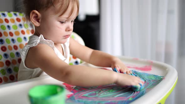 Cute Little Girl Painting with Fingers at Home alt