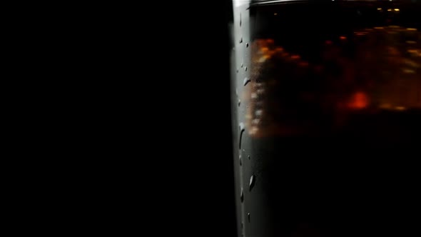 Glass With Whiskey And Soda With Ice Cubes Mix On A Black Background