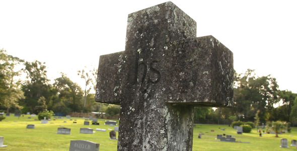 Cross Tombstone In Graveyard