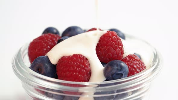 Probiotic Kefir Yogurt Pour On Bowl Of Organic Mixed Berries Spinning ...