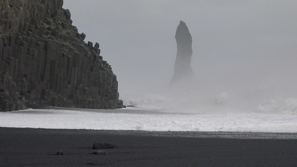 Iceland. Ocean waves hitting against the rocks on a stormy day. Huge waves crash against the rocks. alt