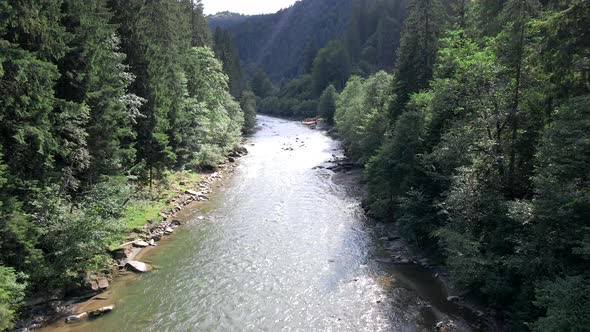 People Rafting at Mountain River Summer Sunny Day alt