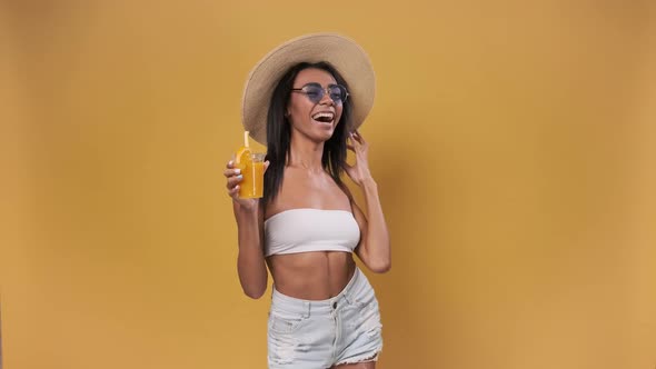 Happy African American Woman Dressed in Summer Clothes Drinking a Cocktail Having Fun alt