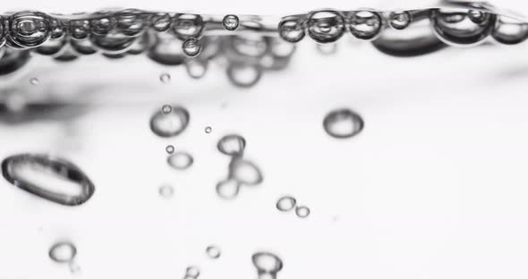 Water Surface Moving As Liquid Pours In And Creates Bubbles alt