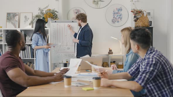 Serious Female Manager Executive and Diverse Team People Analyze Paperwork Talk Work Together Gather alt