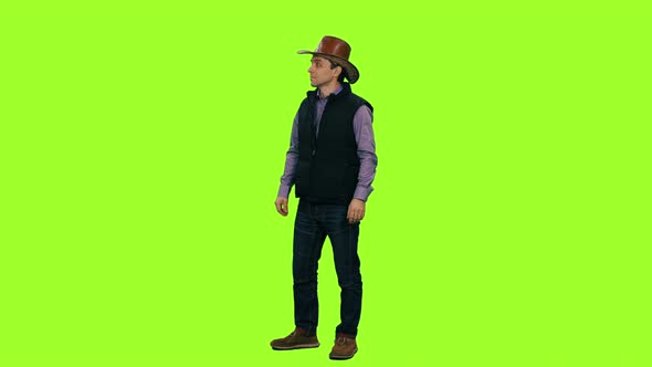 A Man in Cowboy Hat Walks and Meet Someone Against a Green Screen, Chroma Key alt