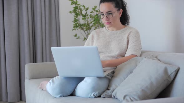 Concerned Thoughtful Caucasian Woman Working on Laptop Computer Looking Away Thinking Solving alt