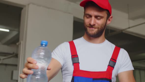 Young Man Worker of Water Factory Checking Quality and Making Inspection in Line Production