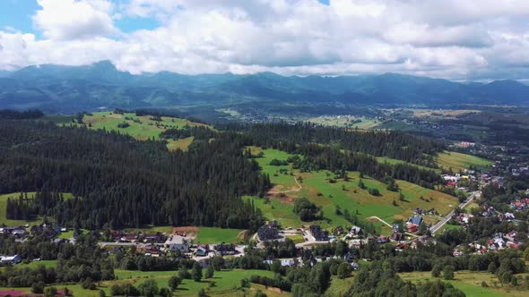 Flight Over a Mountain Cottage Village in Poland, Zakopany, Tatra National Park Aerial 4K Video alt