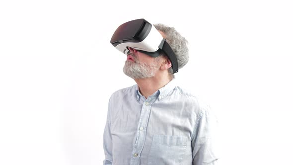 Elderly Looking Man Looking Around in His Vr Goggles and Being in Awe of the Vr Enviorment alt