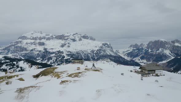 Aerial, Ski Facilities On Top Of Snowy Dolomites Mountains, Little Church In Italy