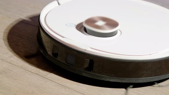 Robot Vacuum with Flashing Indicator Cleans Floor in Room alt