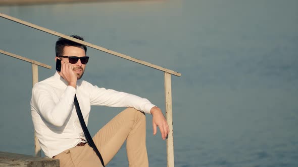 Businessman Talking On Phone.Man In Sunglasses Using Mobile Phone And Call.Man Talking By Smartphon alt