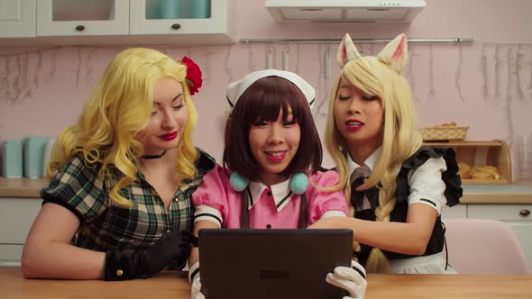 Cheerful Multiracial Women Cosplayers with Tablet Pc Video Conferencing Online alt